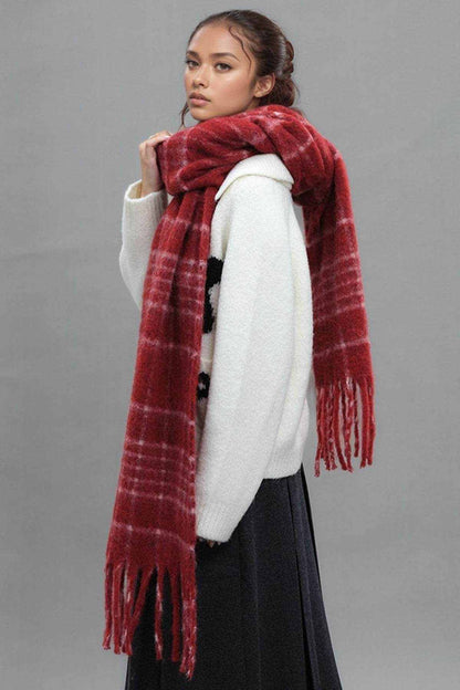 woman wearing red fringe plaid thermal scarf with white sweater and black skirt