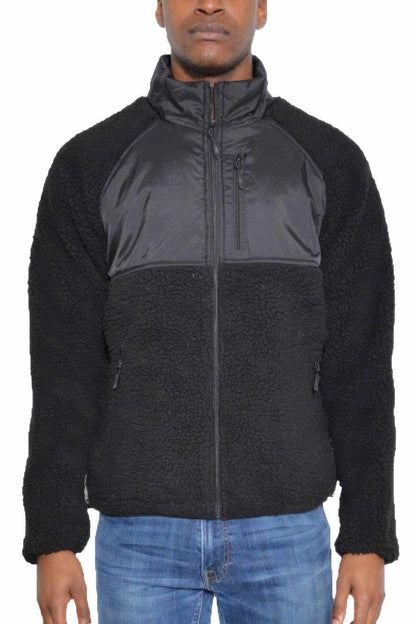 Men's black full zip sherpa jacket with zippered chest and side pockets, made of warm polyester fleece.