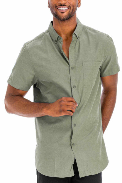 Man wearing casual short sleeve solid shirt in olive green with button-down front and chest pocket