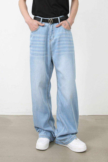 Men's wide leg jeans in light blue with pockets and no stretch, styled with a black belt and white sneakers